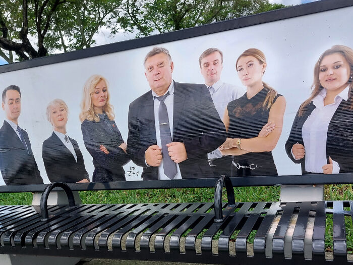 Billboard showing a group of people in business attire with awkward expressions; a funny ad fail.