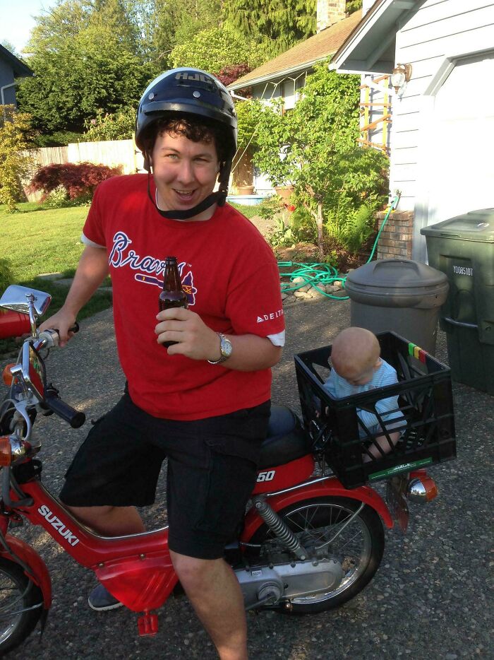 Man wearing helmet on scooter with a baby in a crate, showcasing hilarious in-laws humor.