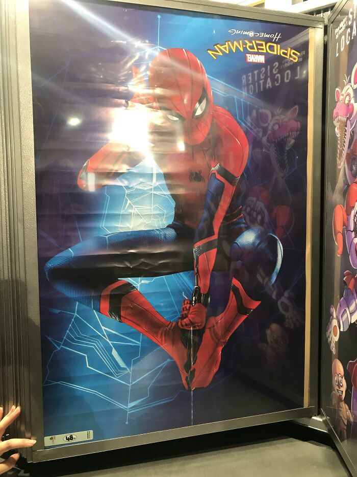 Upside-down Spider-Man poster in a frame, showcasing a funny-ad-fail in vibrant colors.