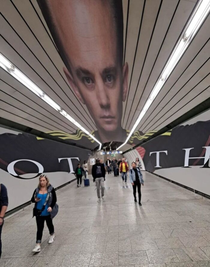 Subway tunnel ad fail featuring a distorted giant face on the ceiling.