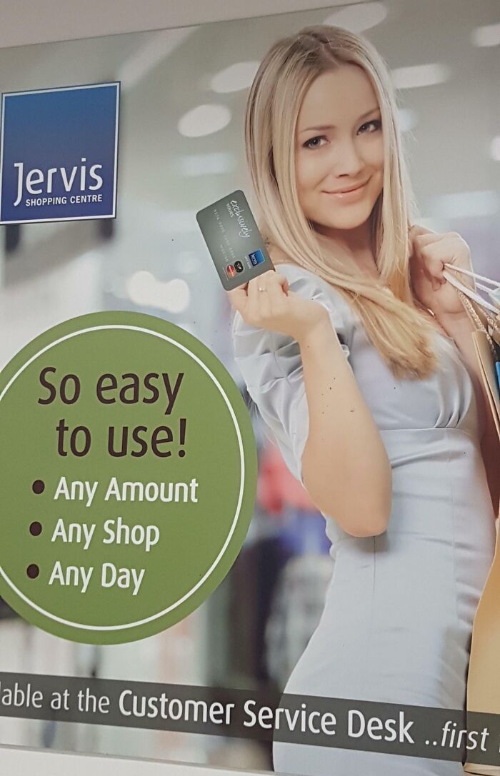 Woman holding a credit card with text "So easy to use!" at Jervis Shopping Centre for funny ad fails.