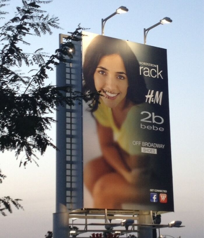 Billboard outdoors showing a smiling woman, branded with Nordstrom Rack, H&M, and others, exemplifying funny ad fails.