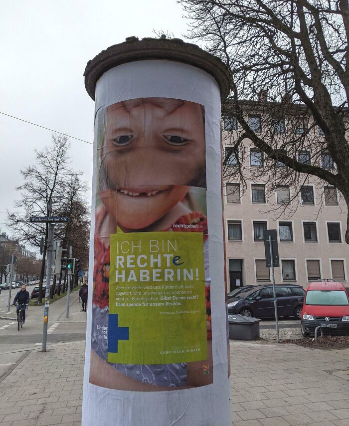 Funny ad fail with an upside-down face poster on a city pillar.