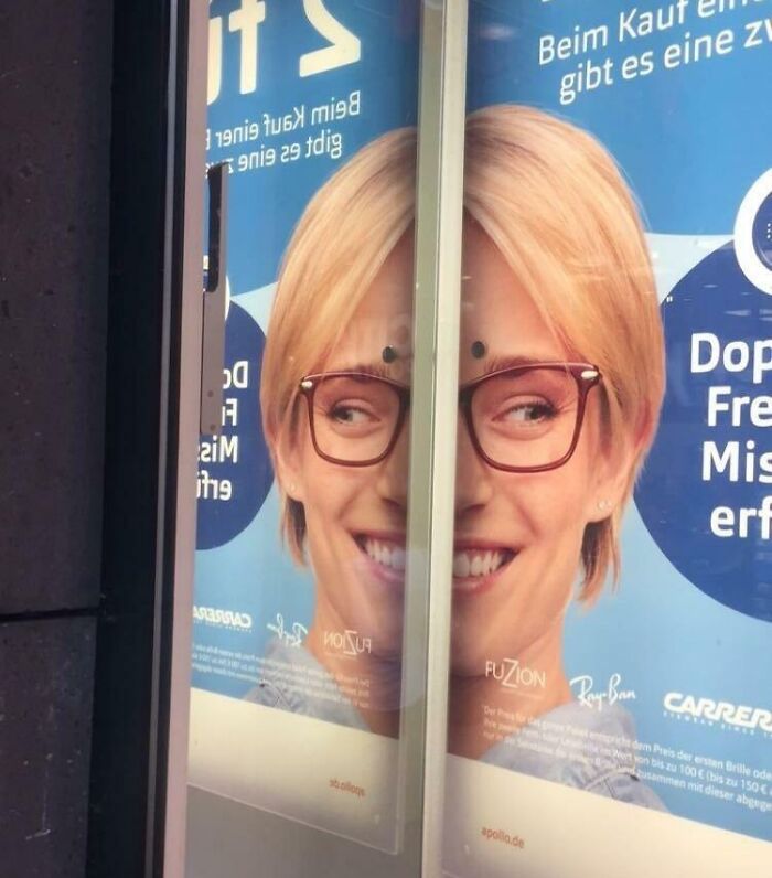 Advertisement misalignment on sliding glass doors, creating a humorous effect.