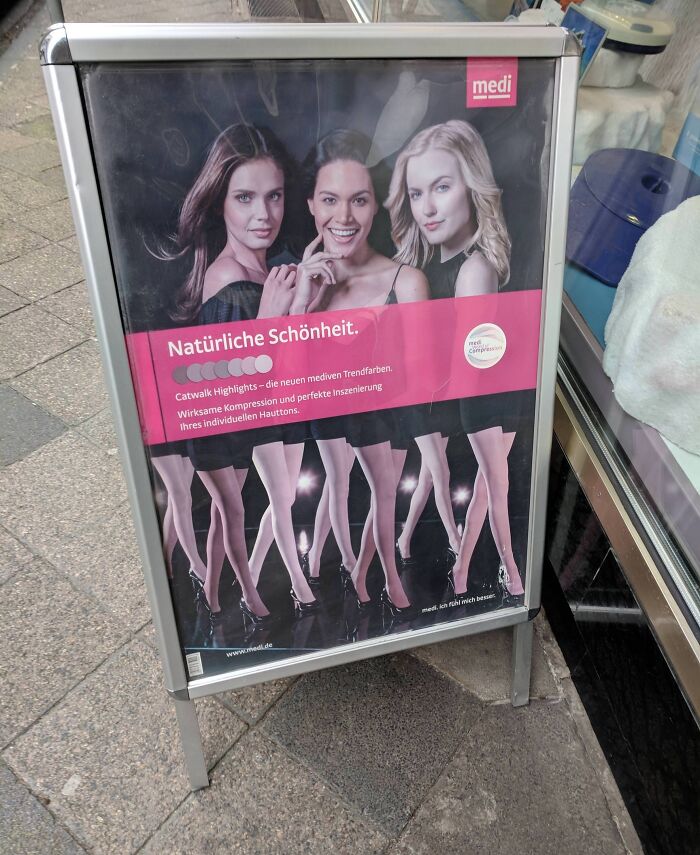 Funny ad fail showing a poster with women's upper bodies misaligned with different lower legs in high heels.