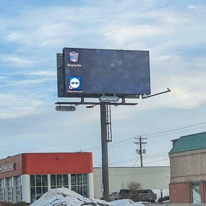 Billboard showing a computer desktop with icons, illustrating a funny ad fail.