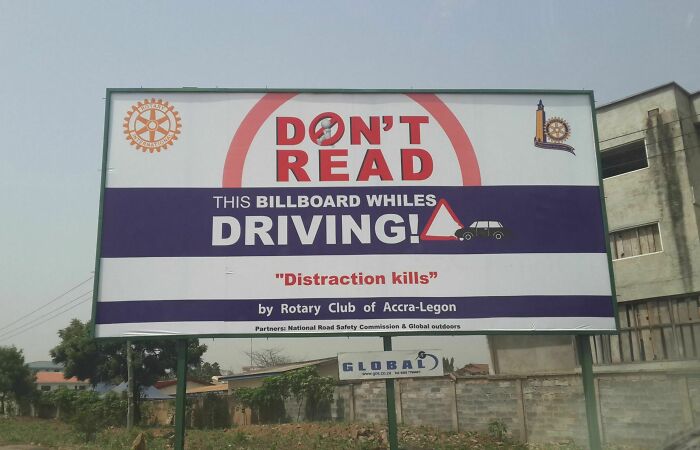 Billboard with ironic message warning against reading while driving; an example of funny ad fails.