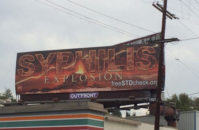 Billboard with "Syphilis Explosion" text, showcasing a funny ad fail in a public space.