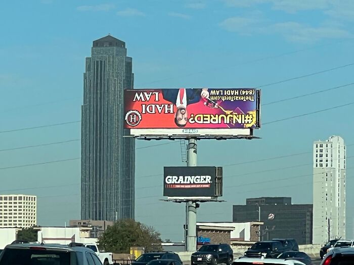 Upside-down lawyer billboard, a classic example of funny ad fails against a cityscape.