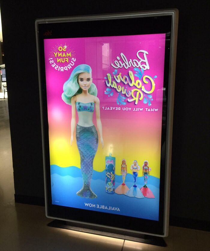 Funny-Ad-Fails: Barbie poster mistakenly displayed backwards inside a light box.