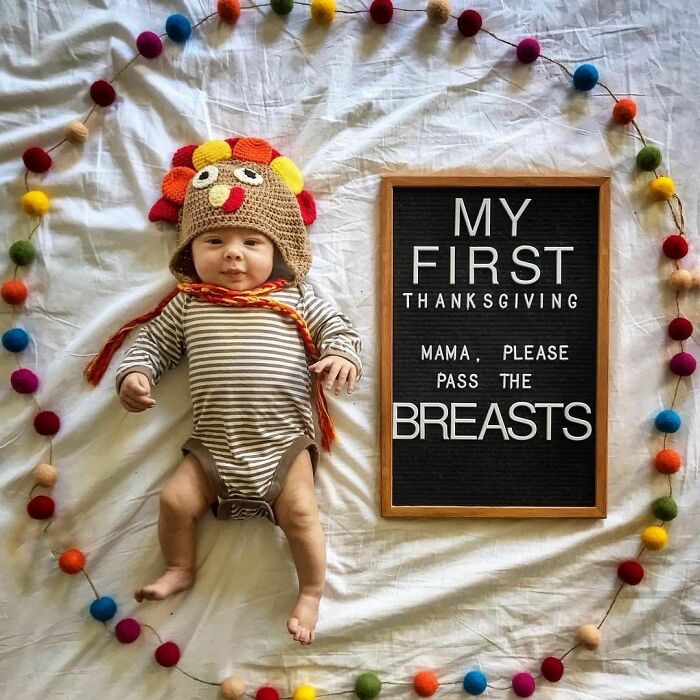 Baby in a turkey hat lying beside a funny Thanksgiving message, surrounded by colorful pom-poms. Women-In-Real-Life-Pics.