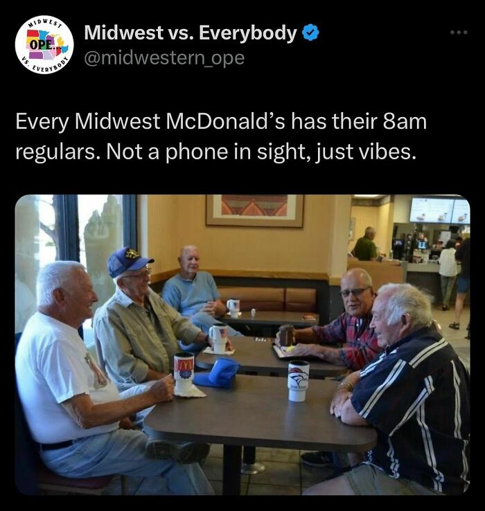 Group of older men chatting in a Midwest McDonald's, enjoying coffee and morning camaraderie.