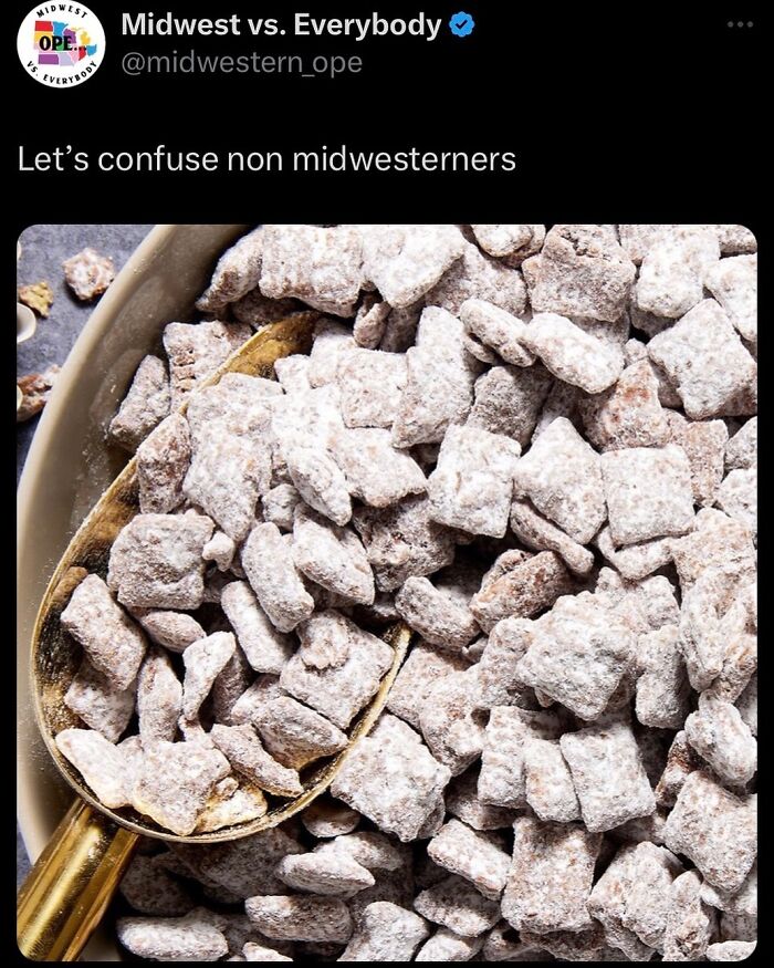 Midwest snack mix with powdered sugar in a bowl and a golden scoop.