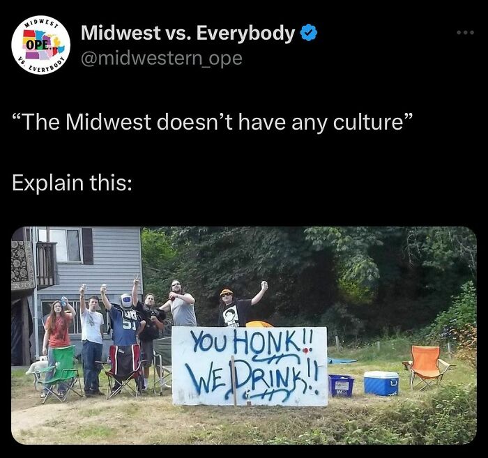 Group of people in the Midwest standing with a "You Honk, We Drink" sign in a yard.