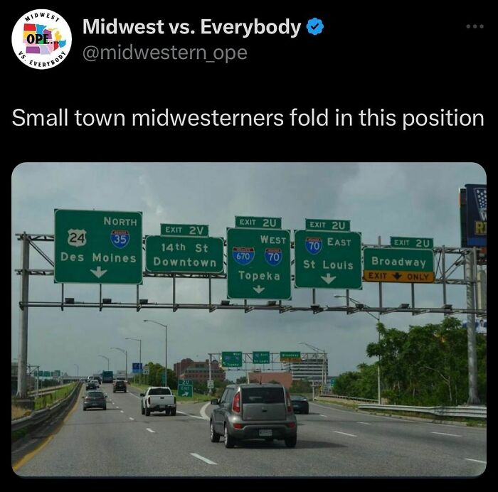 Highway signs in the Midwest showing directions to Des Moines, 14th St, Topeka, St Louis, and Broadway.