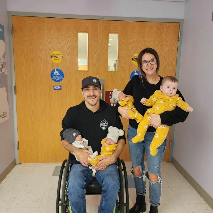 Smiling couple with triplets in yellow outfits, symbolizing a wholesome adoption story.