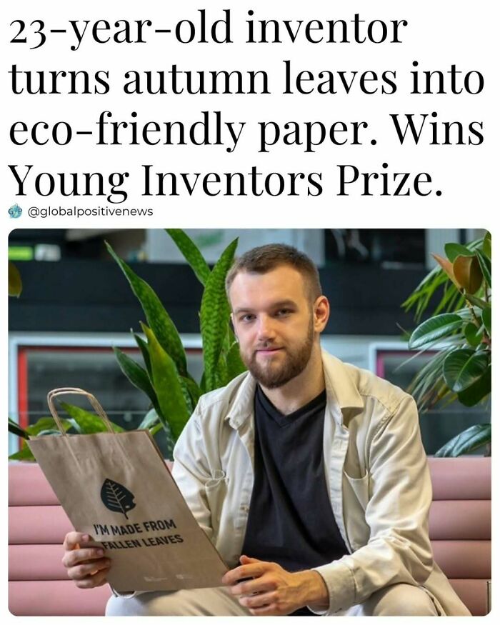 Young inventor holding eco-friendly paper made from leaves, smiling in a plant-filled setting, highlighting uplifting innovation.