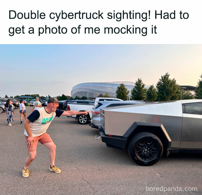 An E meme with a man humorously posing beside a Cybertruck, showcasing the funny side of the electric future.