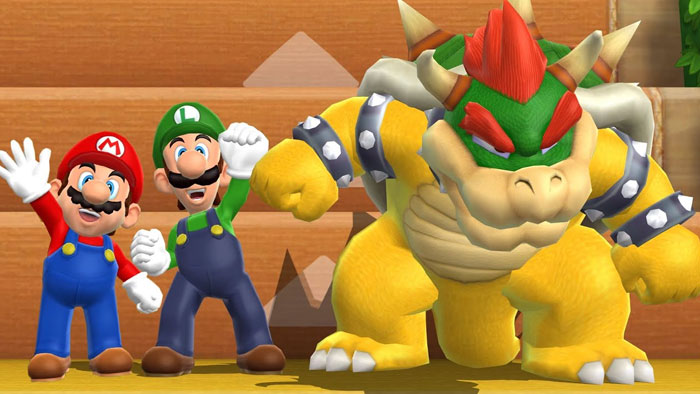 A famous trio from the Mario series, featuring Mario, Luigi, and Bowser standing together in a colorful game environment, with Mario and Luigi cheering.