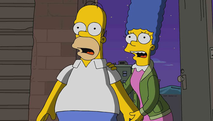 A fat cartoon character, Homer Simpson, with bulging eyes and a surprised expression, stands beside his blue-haired wife, Marge Simpson, at night.