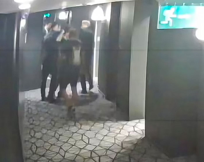 CCTV footage of a group in a corridor with dim lighting, related to Liam Payne's final moments.