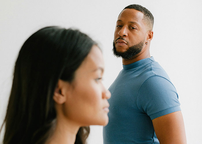 Two people standing, one looking forward and the other in the background, capturing the essence of gut feelings.