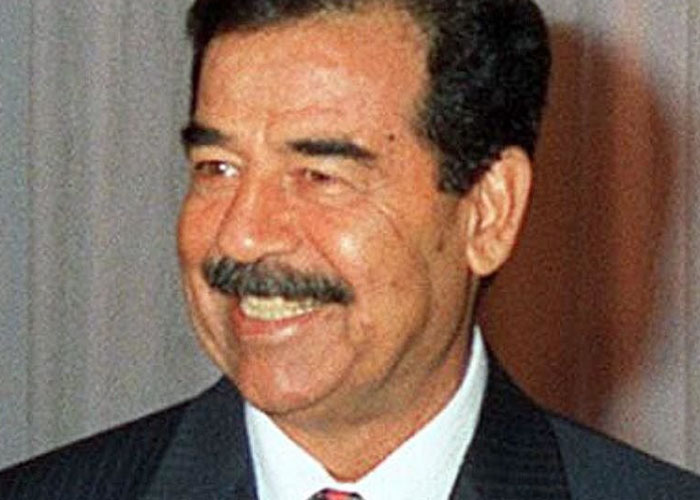 A man smiling, wearing a suit, illustrating an unpleasant gut feeling being right.