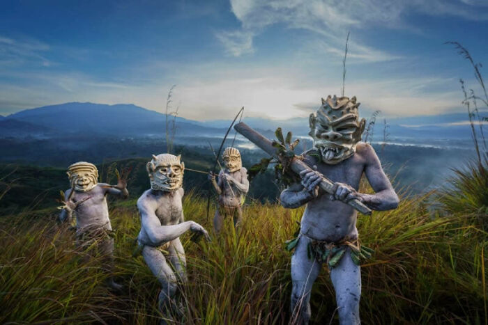 Four masked figures in nature, symbolizing sustainability in breathtaking photography for Hipa 2024.