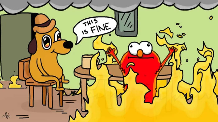 An Elmo fire meme crossover with "This is fine" dog. Elmo and the dog sit amid flames, with the dog saying, "This is fine," while Elmo raises his arms.