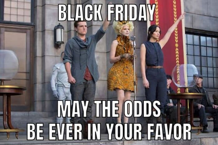 Characters in a dystopian scene with "Black Friday" and "May the odds be ever in your favor" text, creating a funny meme.