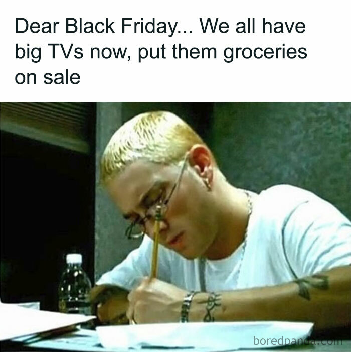 Man with glasses writing a letter about Black Friday, humorously suggesting grocery discounts.