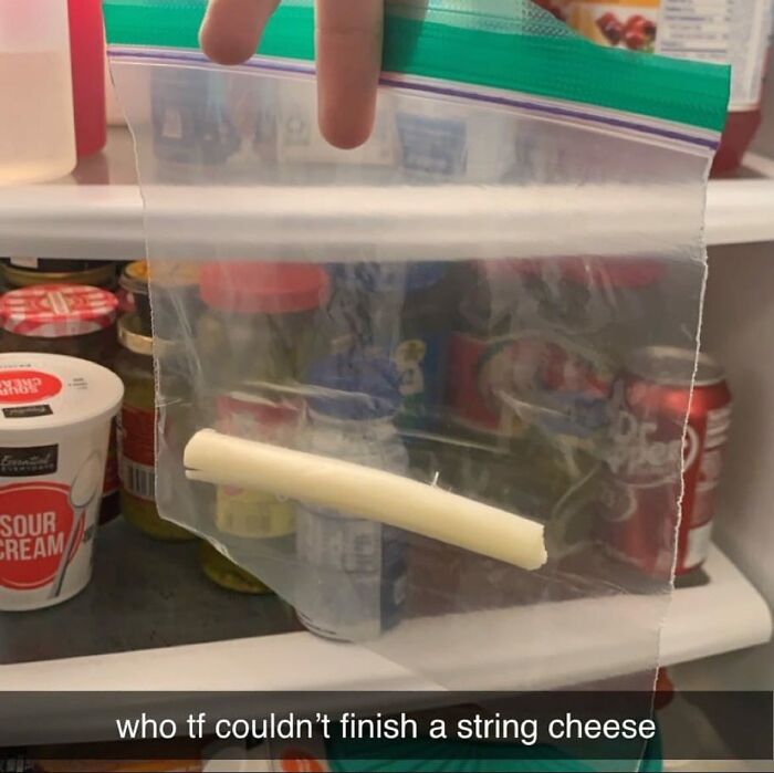 String cheese piece in a plastic bag inside a cluttered fridge; humorous example of a chaotic dude fridge.