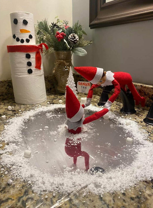 "Elf On The Shelf idea with two elves, one appearing to rescue the other from a sink 'ice pond' marked with 'Danger Thin Ice' and surrounded by fake snow."