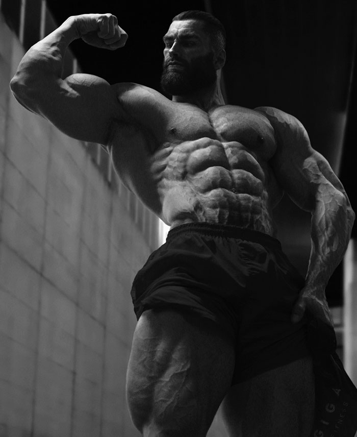 A grayscale image of a muscular man flexing his bicep and showcasing his physique, often linked to the Giga Chad meme concept.