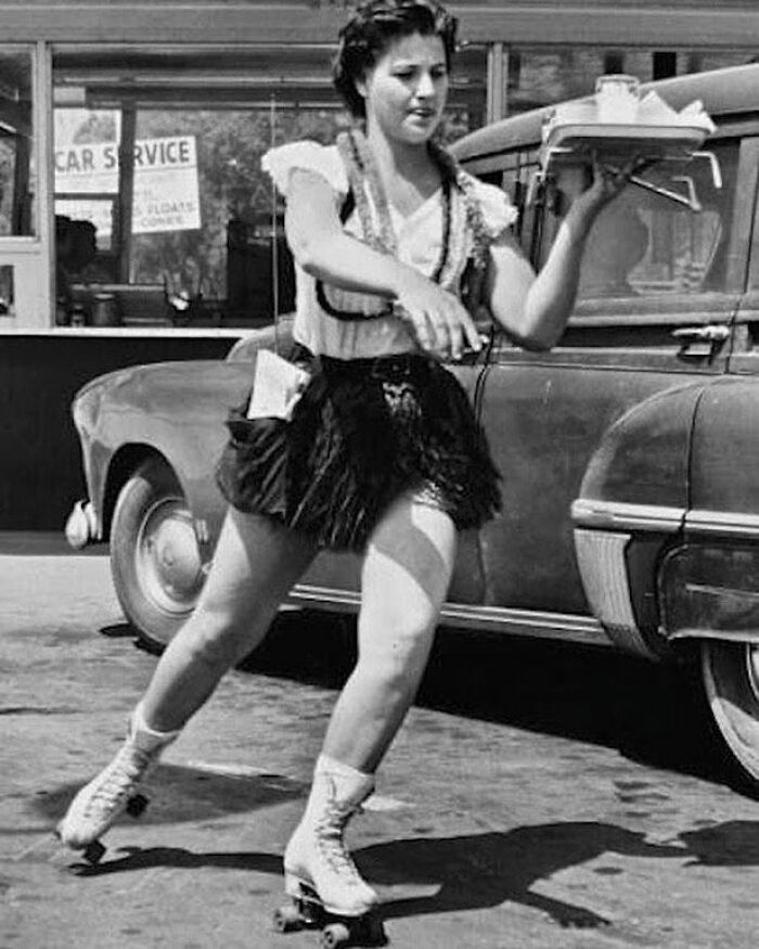 A Waitress On Roller Skates Delivers A Tray Full Of Food To Customers. 1940s