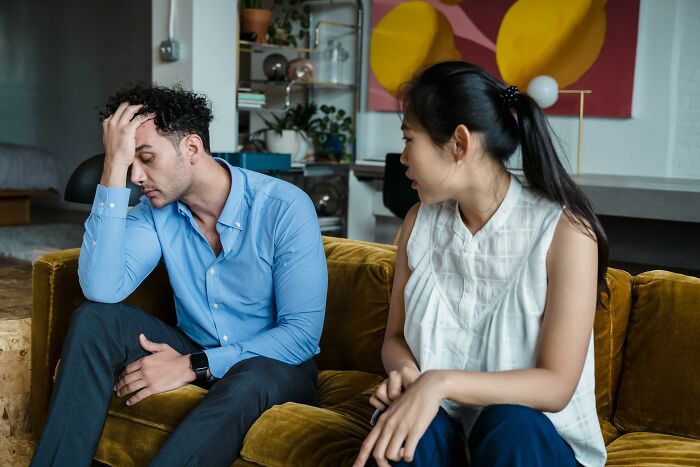 Woman annoyed at partner on couch, deciding to leave due to lack of commitment.