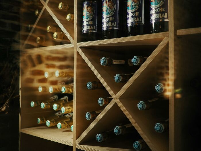 Home wine cellar with stacked bottles indicating wealth.