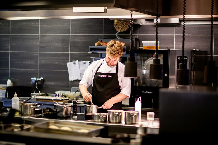 Chef in a modern kitchen with luxury appliances, suggesting the person was loaded.