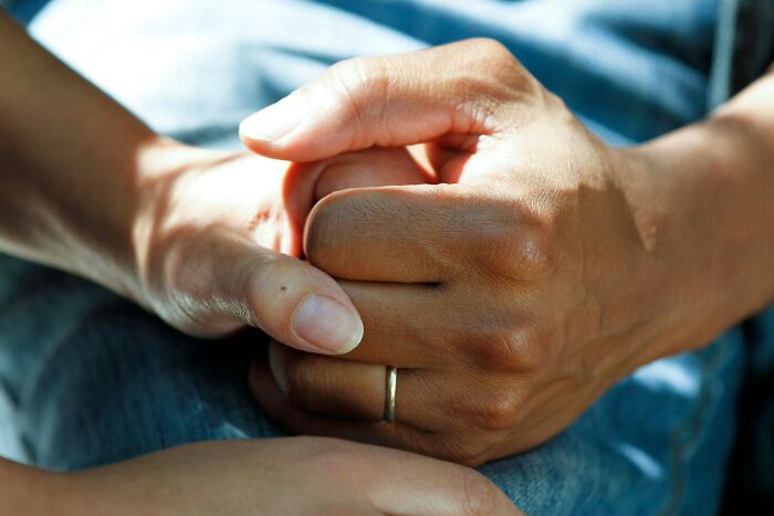 Close-up of hands with a wedding ring, symbolizing moments questioning marriage decisions.