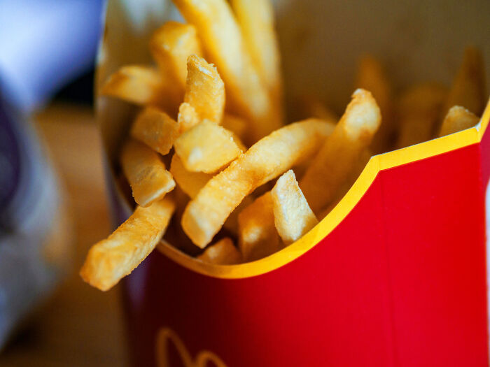 Close-up of fast food fries in a red box.