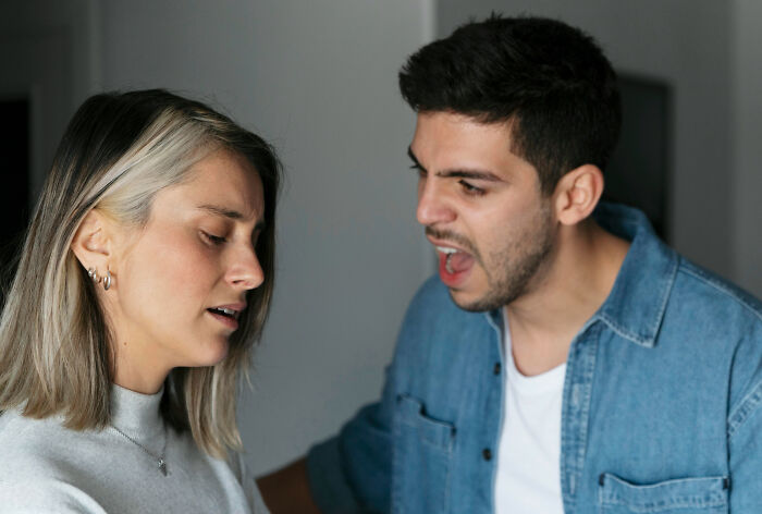 A couple in a heated argument, reflecting a moment of doubt about marrying the person.