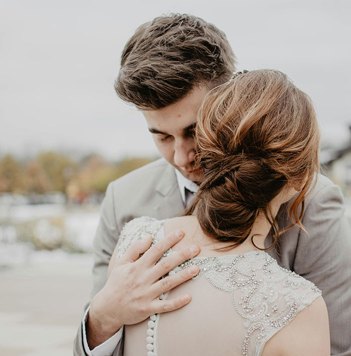 A couple embraces closely, symbolizing marriage challenges.