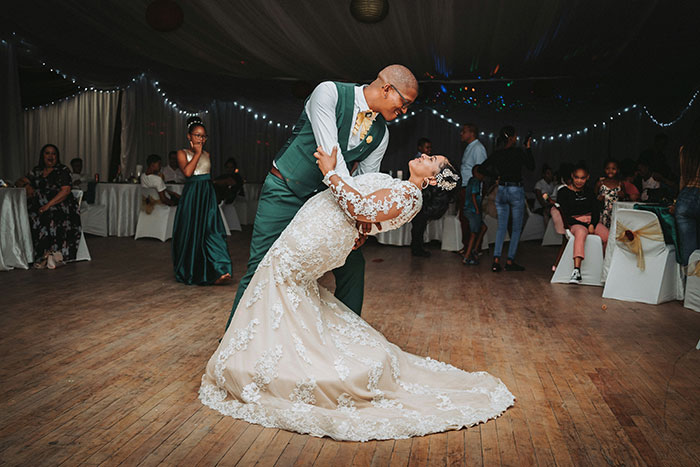 Couple dancing on their wedding day, surrounded by guests, highlighting potential marriage issues.