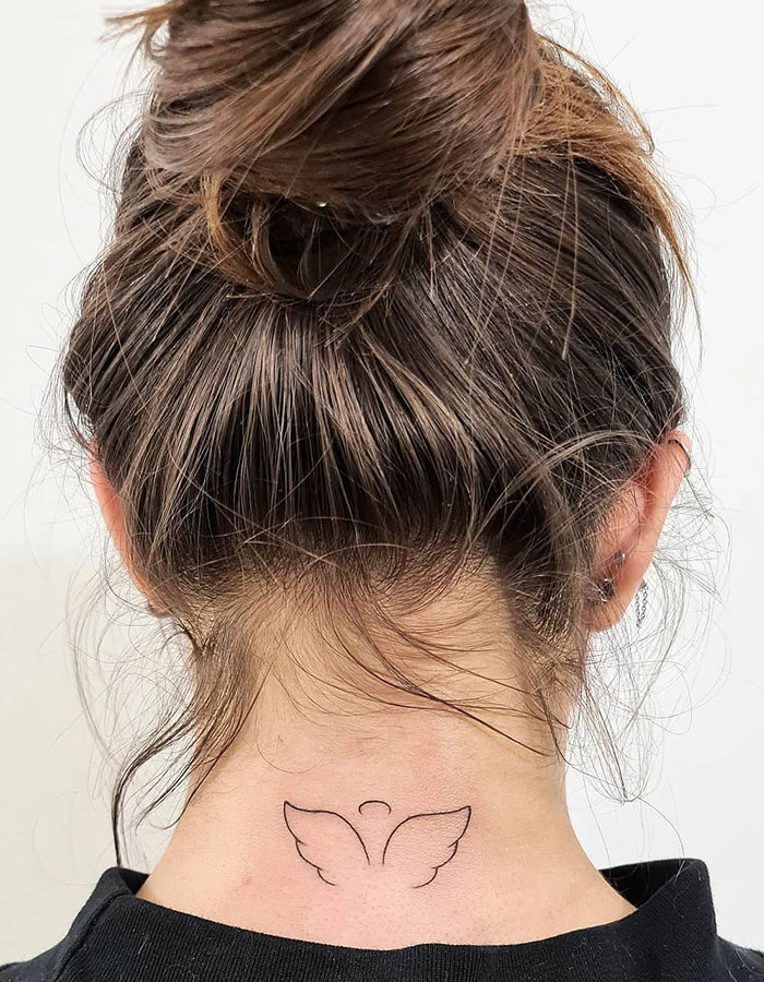 A tattoo idea for women with a minimalist tattoo design on a woman's neck, featuring angel wings for a subtle tattoo idea.