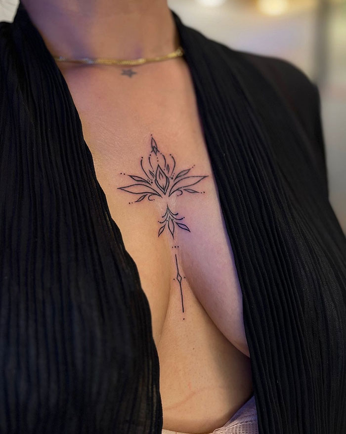 Elegant floral chest tattoo idea for women, showcasing delicate lines and subtle design.