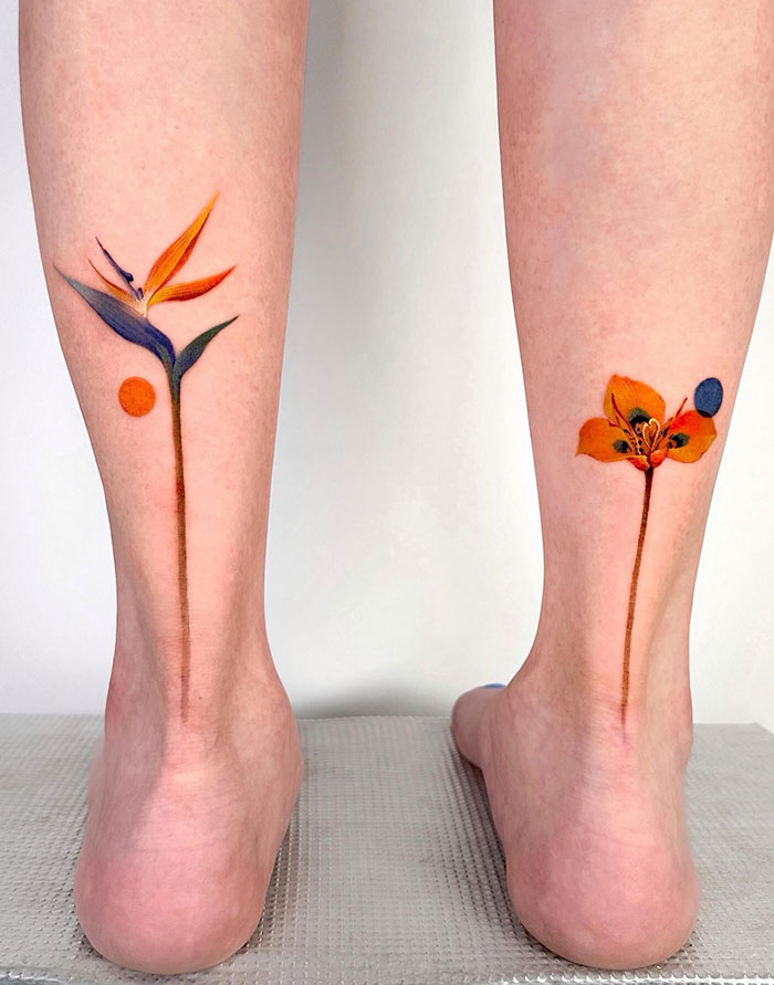 Colorful flower tattoos on the back of a woman's legs, showcasing unique tattoo ideas for women.