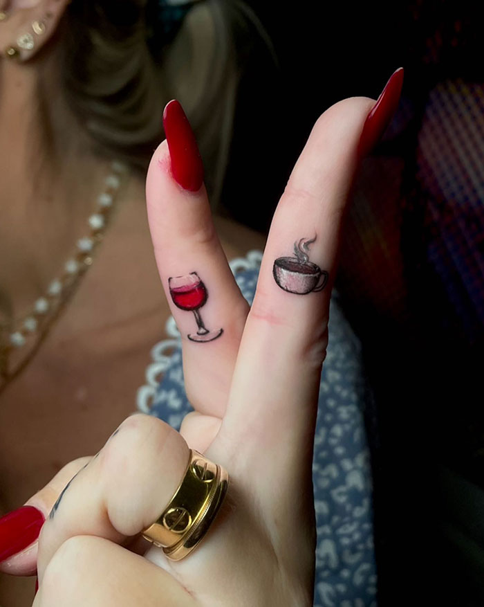 Finger tattoos on women with cup and wine glass designs, showcasing subtle and daring tattoo ideas for women.