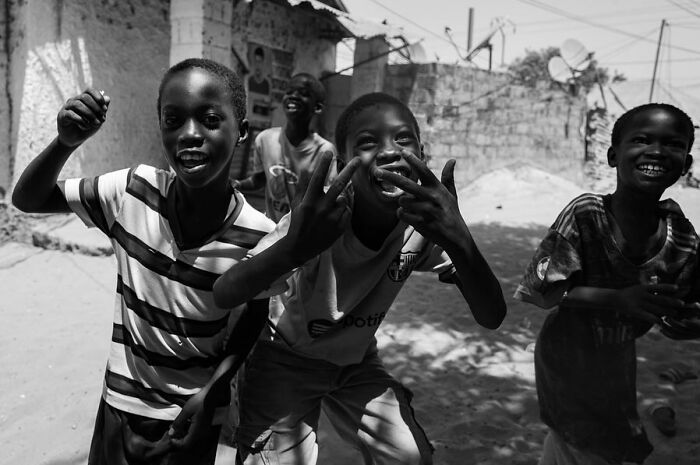 Children laughing and playing in a street, captured by Ivan Margot.