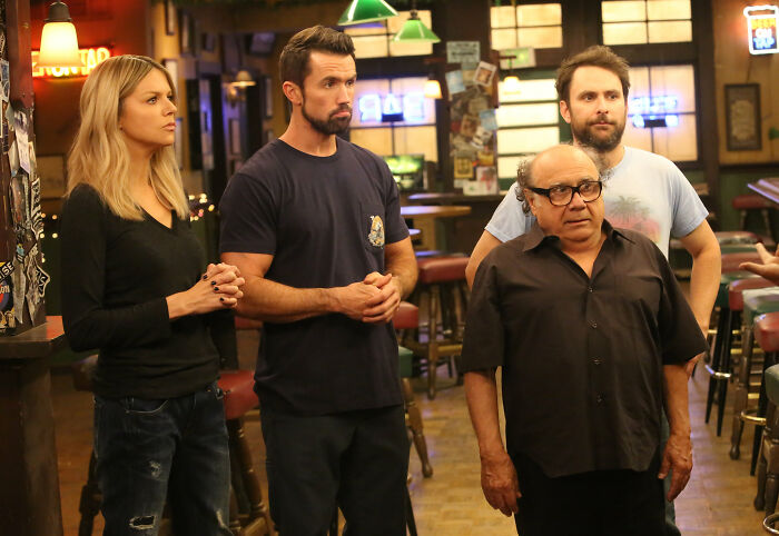 Group of people in a bar setting, embodying fascinating fan theories discussion.