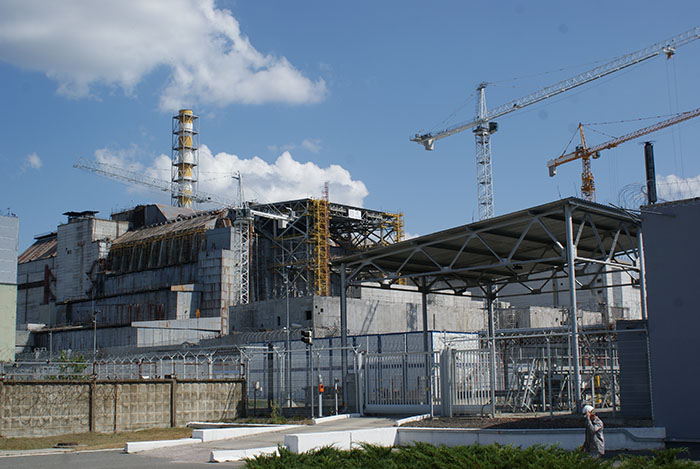 Chornobyl site with cranes and structures, related to genetically different dogs living nearby.